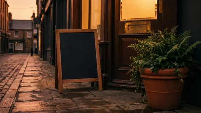 Local SEO Services – What Local SEO Includes – Caleb Schallert Local SEO services — a shop's front step with a blank chalkboard, a full planter and a brass door plate — Caleb Schallert.